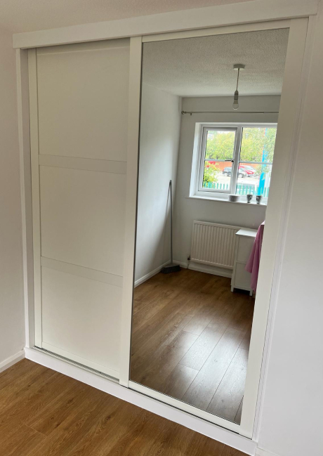 A very well fitted white and mirrored sliding wardrobe door